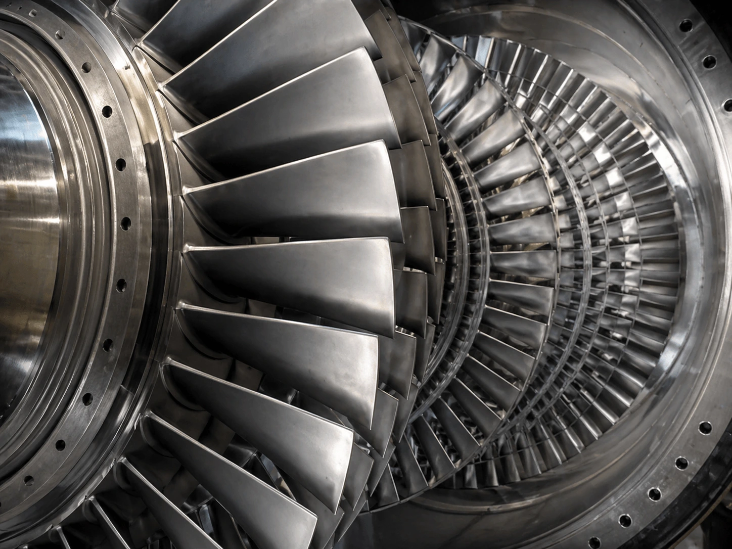Close-up of industrial steam turbine blades inside a rotor casing showing precision-cast airfoils ready for repair inspection